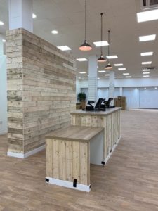 Retail store with sanded pallet wood wall cladding